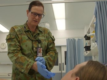 DEFGLIS Medical Affirmation An Army medical officer and member of DEFGLIS wearing DPCU providing medical care to a patient who is out of shot